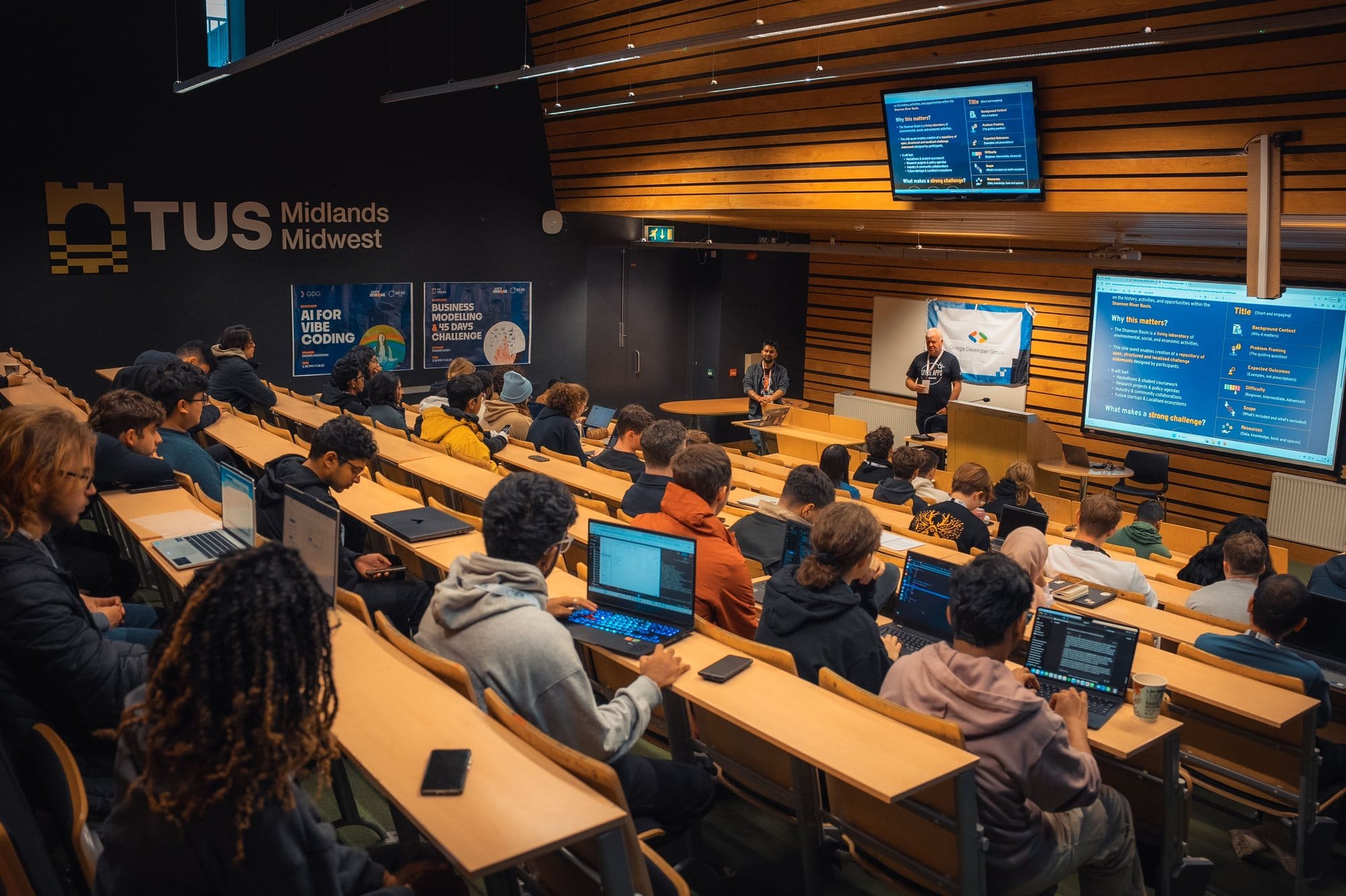 Participants with laptops in a TUS lecture theatre during a partner session at HackAthlone 2025